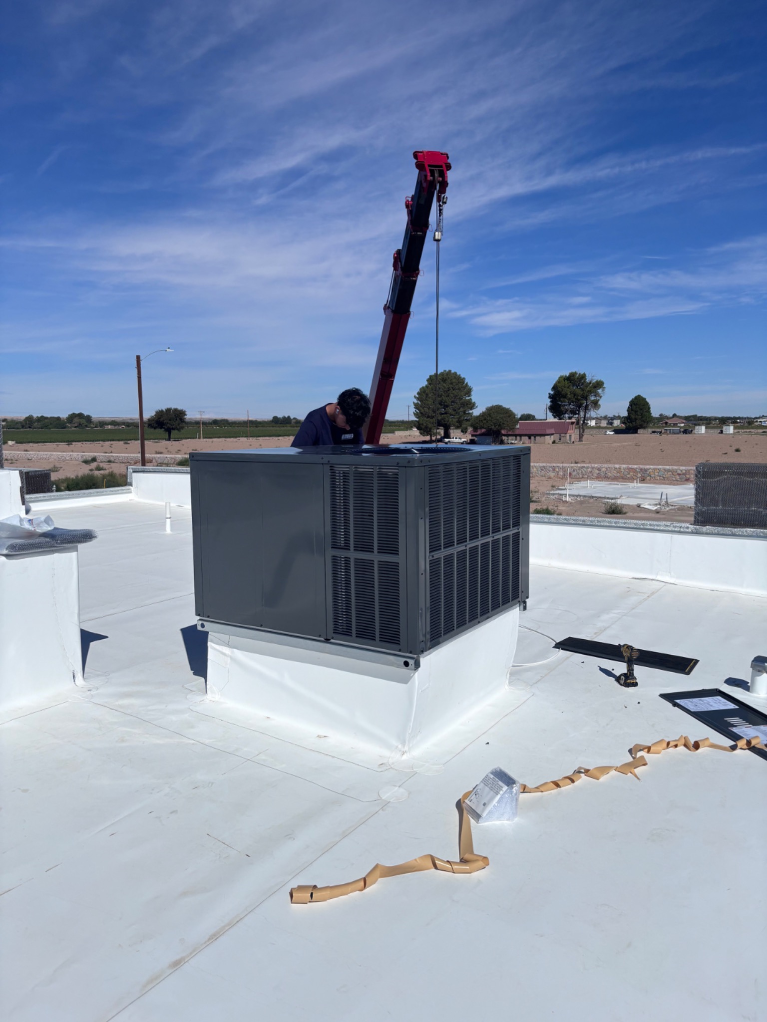 Elite Improvement Co rooftop HVAC installation with crane